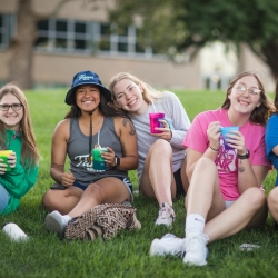 students sitting on grass