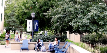 College of Saint Mary students walk and relax on campus.