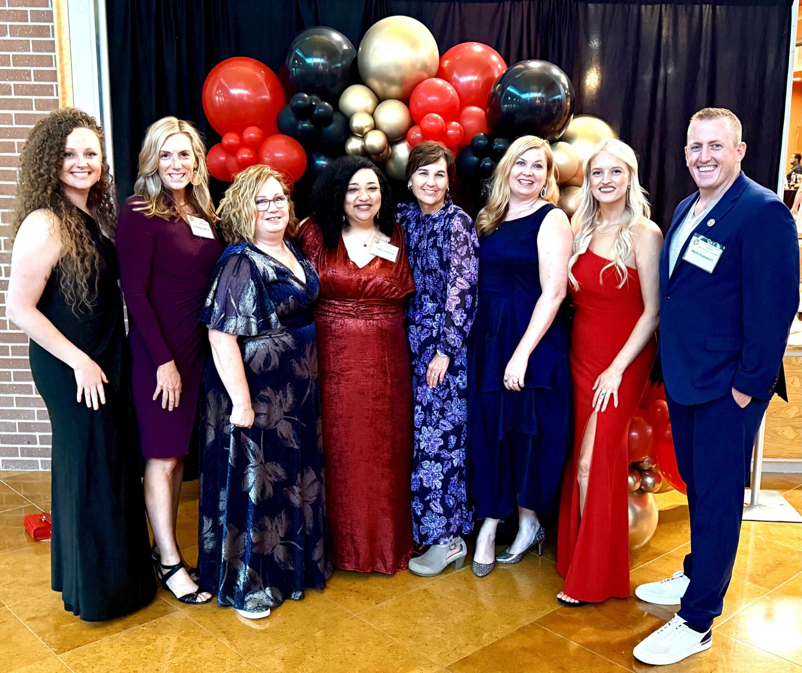 Physician assistant studies faculty wearing formal clothes pose at the NAPA gala.