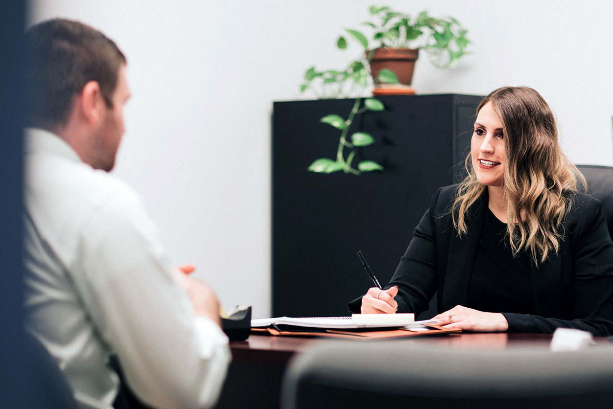 Woman finance professional meets with a colleague in an office.