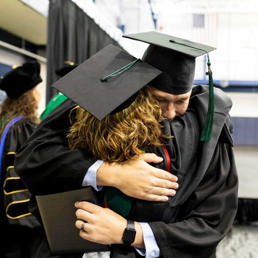 recent MSPA graduate hugging a CSM PA faculty member during graduation on campus in Omaha, Nebraska
