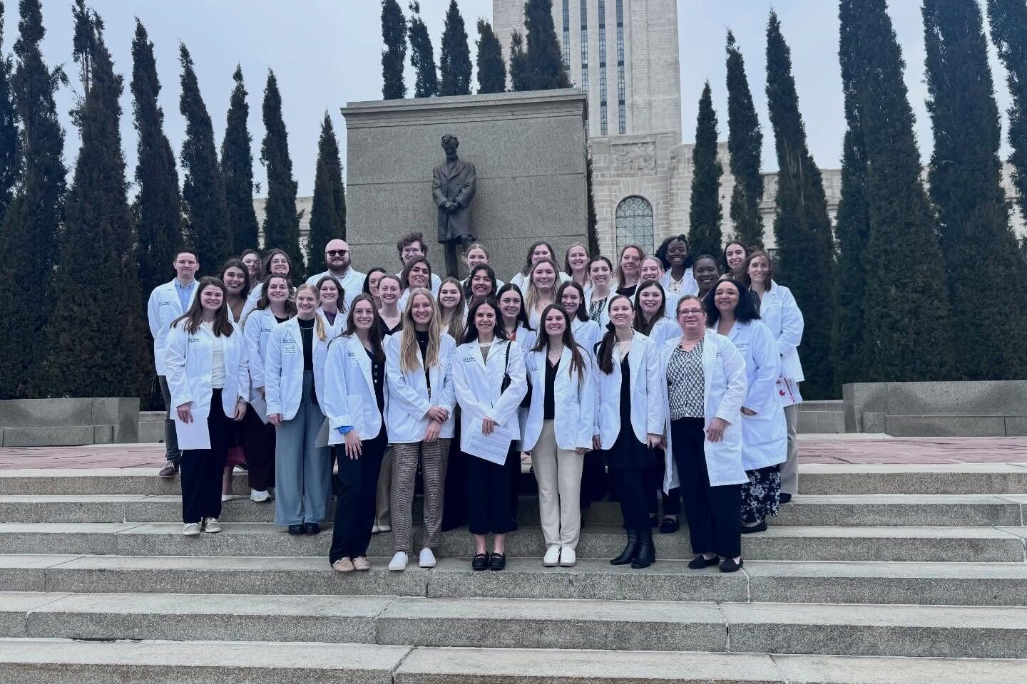 College of Saint Mary Master of Science in Physician Assistant Studies program students and faculty gather on stairs at Nebraska Capitol Hill building in Lincoln advocating during legislature session.