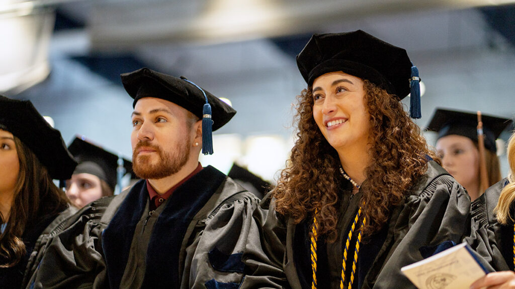 doctorate students in cap and gown