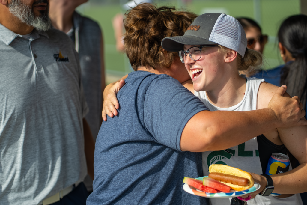 Students hugging at College of Saint Mary homecoming picnic