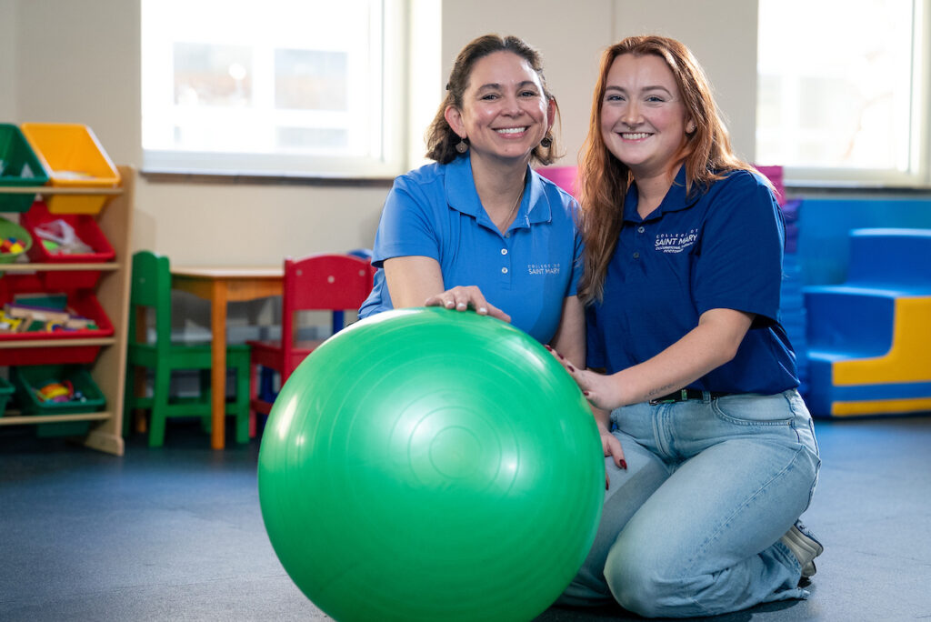 two women with therapy ball