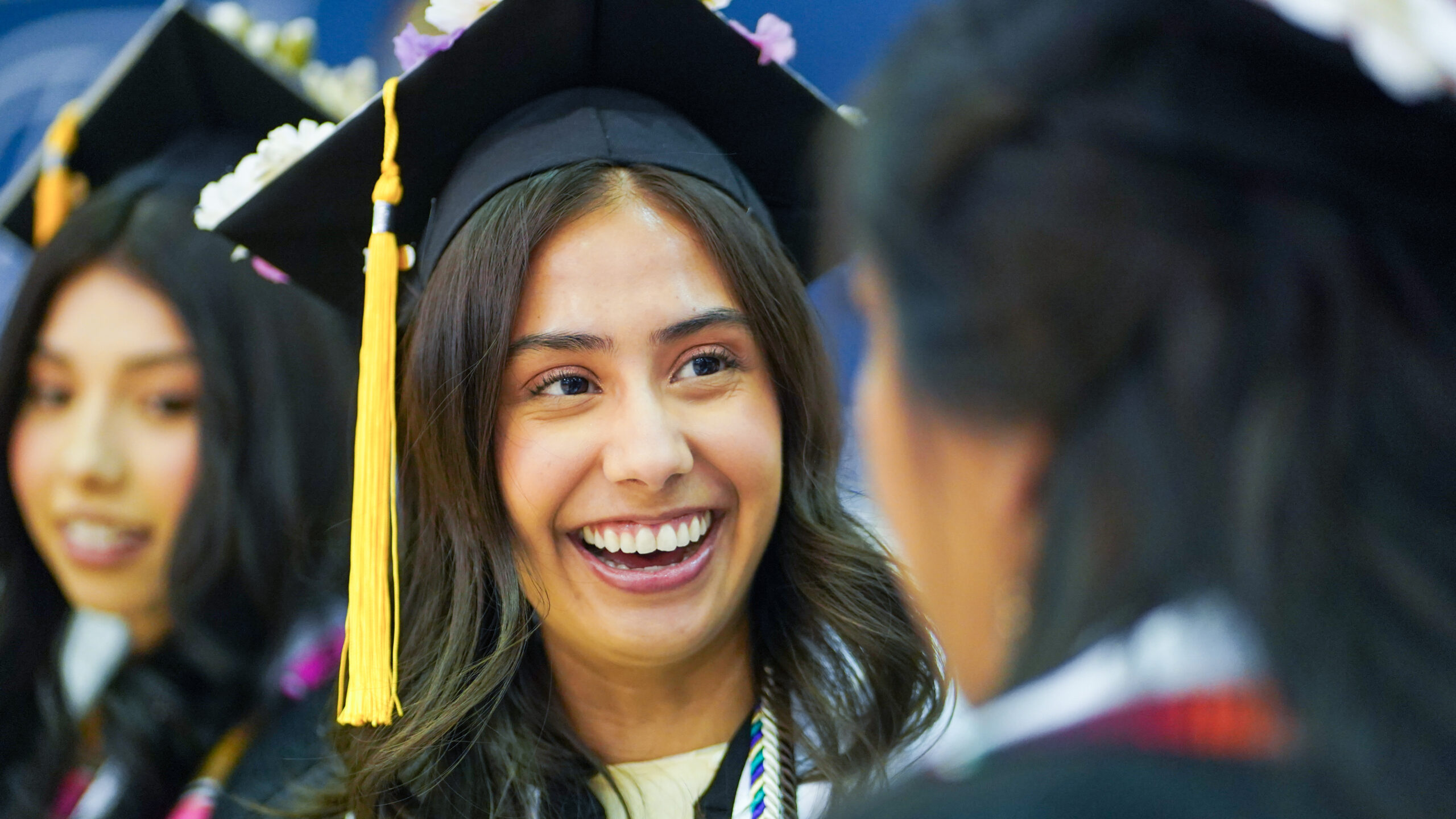 A student in her cap and gown at commencement