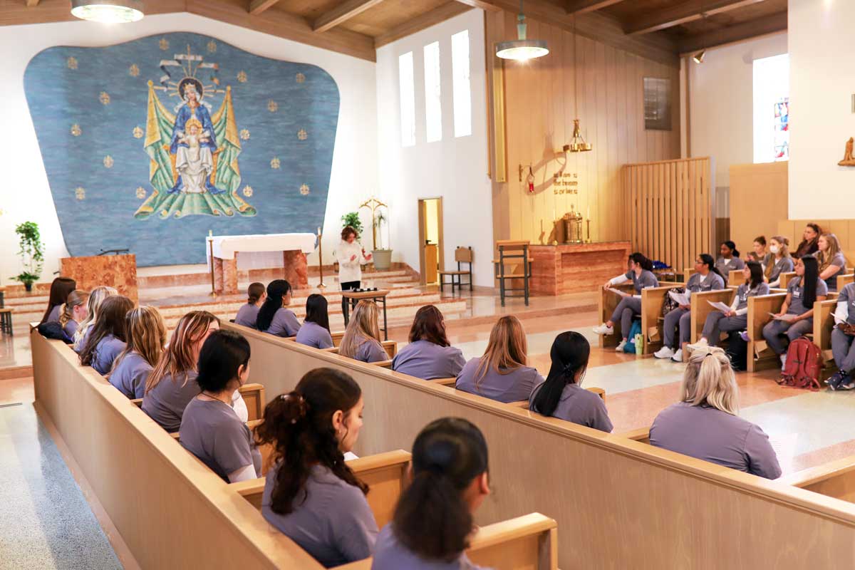 Nursing students line pews in Our Lady of Mercy Chapel at College of Saint Mary for their Blessing of the Hands ceremony.