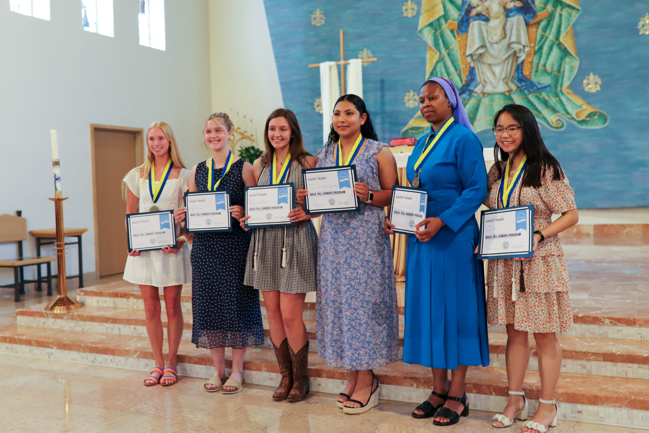 Students stand in the chapel with their certificates during the 2026 Honors Convocation.