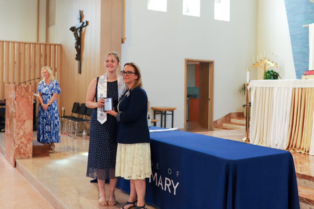 BSN graduate Lilly Praest receives the Spirit of Nursing Award at the BSN pinning ceremony.