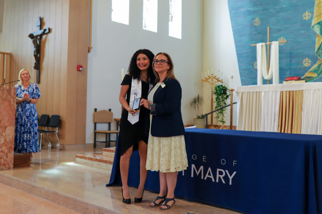 BSN graduate Melissa Sanchez receives the Outstanding BSN Student of the Year award at the nursing pinning ceremony.