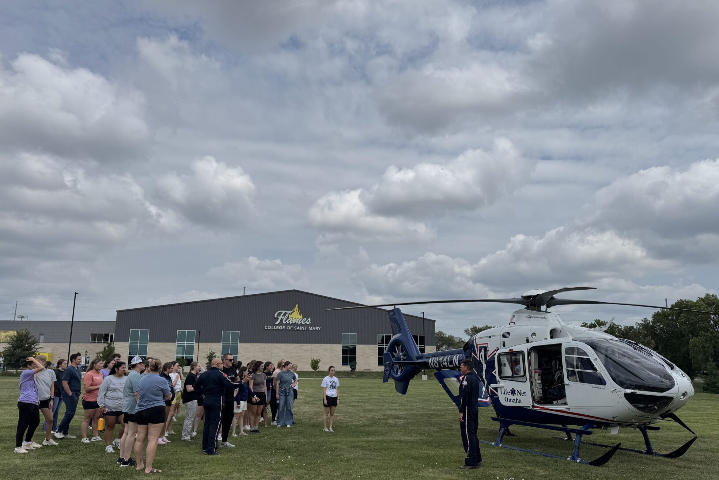 Physician assistant studies students learn from a helicopter pilot and medical personnel.