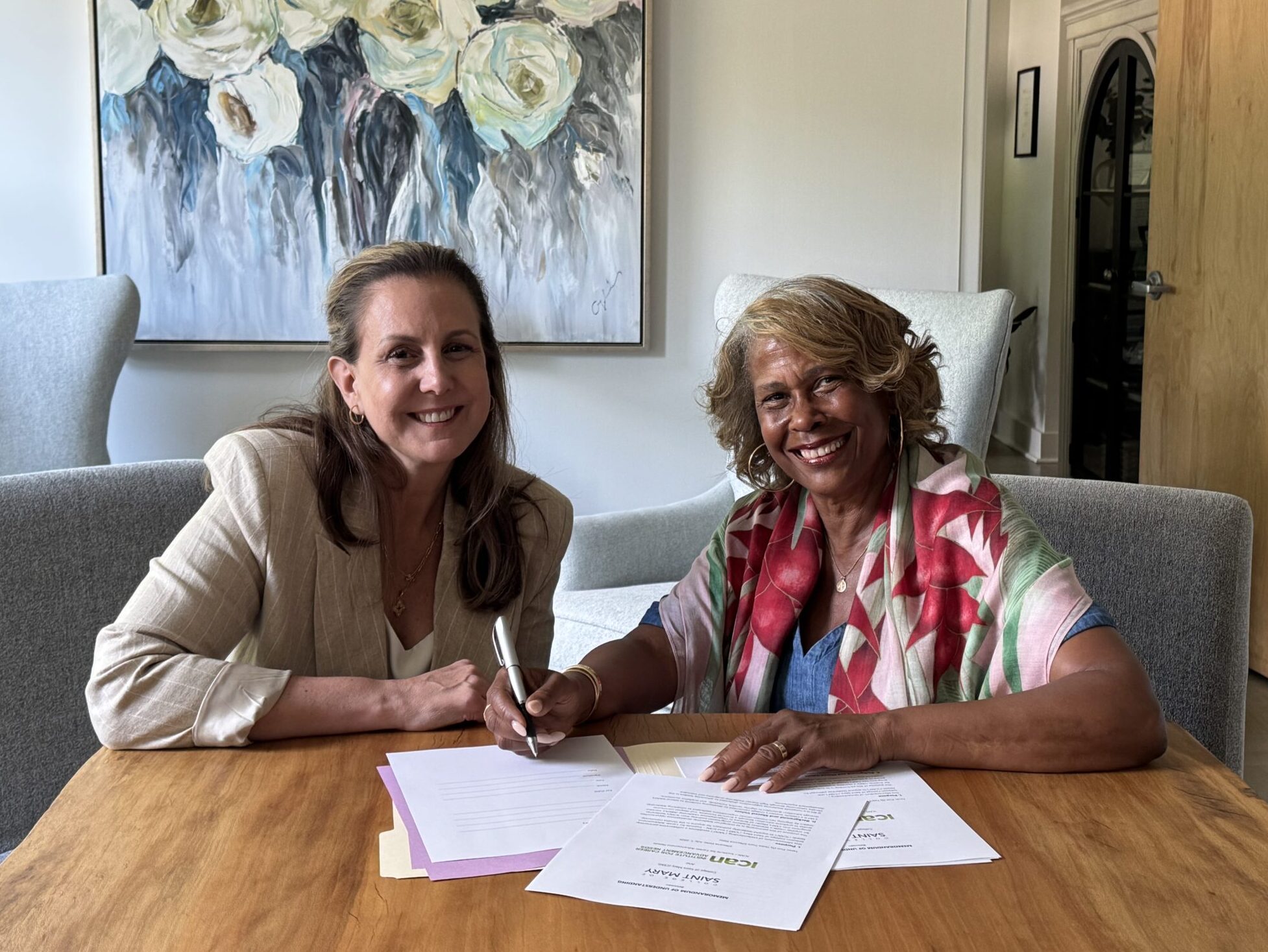 CSM President Heather Smith signs an agreement with ICAN President and CEO Aileen Warren